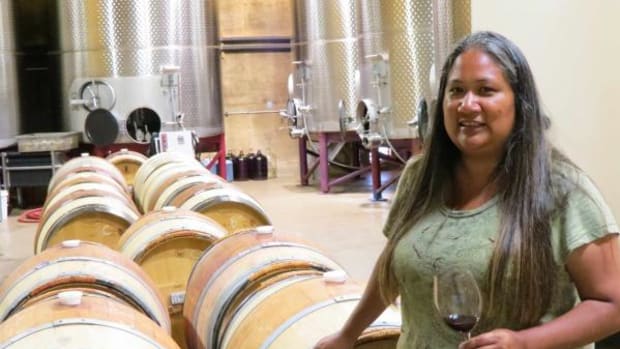Tara Gomez, 39, tastes wines still aging in oak casks in the cellar of California's Santa Ynez Band of Chumash Indians. She is the first Native winemaker with a degree in enology to manage both the vineyard and the winemaking components of a wine business. (By Lisa Garrigues)