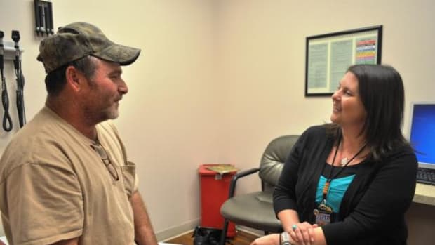 Cherokee Nation citizen James Martins, of Afton, talks with Northeastern Tribal Health System CEO and fellow Cherokee, Kim Chuculate, during a regular visit to the clinic.