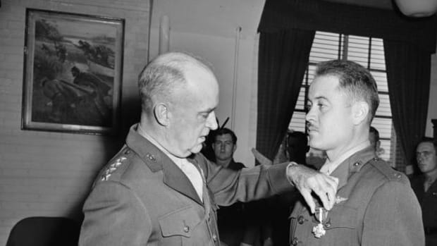 Lt. Col. Gregory (Pappy) Boyington, right, receives the Navy Cross from Gen. A. A. Vandergrift, Marine Corps Commandant during a ceremony at Marine Headquarters in Washington, D.C., Oct. 4, 1945.