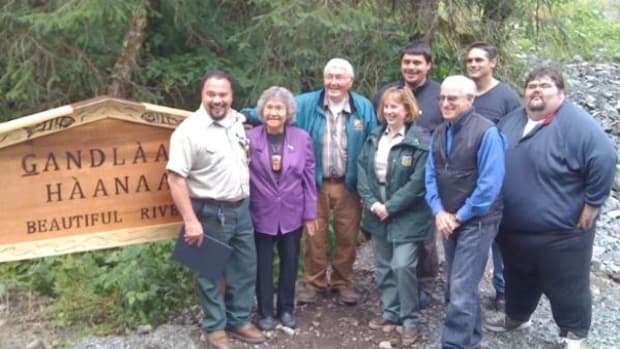 An August 25 creek renaming ceremony brought tribal, conservation and Forest Service representatives together on the bank of what is now known as Gandlaay Haanaa, or Beautiful Creek. Pictured from left: Francisco Sanchez, Craig District Ranger, U.S. Forest Service; Viola Burgess, Hydaburg Cooperative Association; James Williams, Klawock Cooperative Association; Beth Pendleton, Regional Forester, U.S. Forest Service; Anthony Christianson, Mayor Hydaburg; Harris Sherman, Undersecretary for Natural Resources and Environment, USDA; John Huestis, Craig Tribal Association; Richard Peterson, Organized Village of Kasaan.