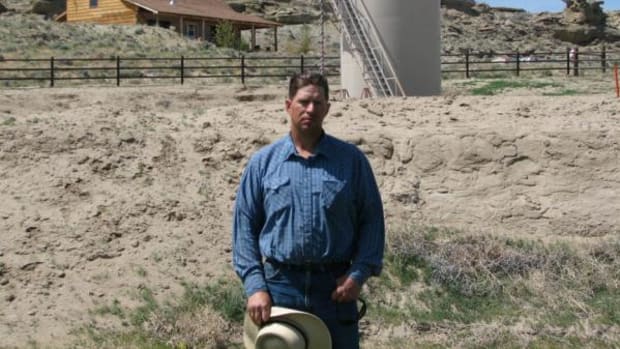 This May 22, 2009 picture shows John Fenton, a farmer who lives near Pavillion in central Wyoming, near a tank used in natural gas extraction, in background. Fenton and some of his neighbors blame hydraulic fracturing, or "fracking," a common technique used in drilling new oil and gas wells, for fouling their well water. The U.S. Environmental Protection Agency announced Thursday Dec. 8, 2011 in Wyoming, for the first time that fracking may be to blame for causing groundwater pollution. The EPA also emphasized that the findings are specific to the Pavillion area. The agency said the fracking that occurred in Pavillion differed from fracking methods used elsewhere in regions with different geological characteristics.
