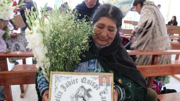 Santosa Tacco Condori shows a tribute to her son, who died on October 13, 2003, during a mass for people killed during the gas war held on October 12, 2013.