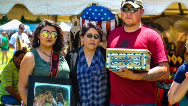 Ruby Wolfe surrounded by her children, Cecilia Wolfe holding artwork depicting Chipa Wolfe, and Joshua Krumnaker holding the beautiful funerary container Sunday May 8, 2016.