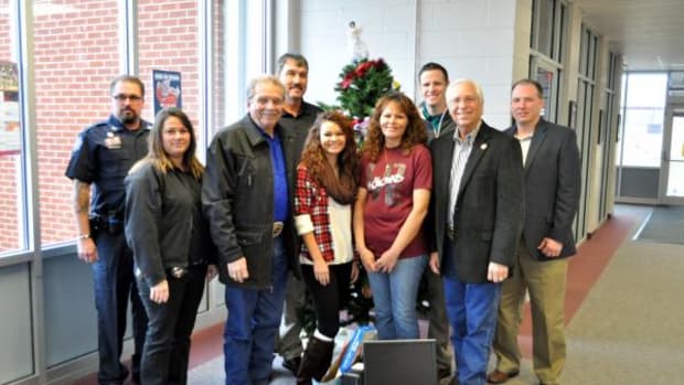 Pictured, from left, are Cherokee Nation Marshal Shannon Buhl, Community Resource Investigator Shawnna Roach, Deputy Chief S. Joe Crittenden, Sequoyah Schools Superintendent Leroy Qualls, Sequoyah sophomore Treanna Washington and mother Dawn, Tribal Councilor David Walkingstick, Principal Chief Bill John Baker and Athletic Director Marcus Crittenden.