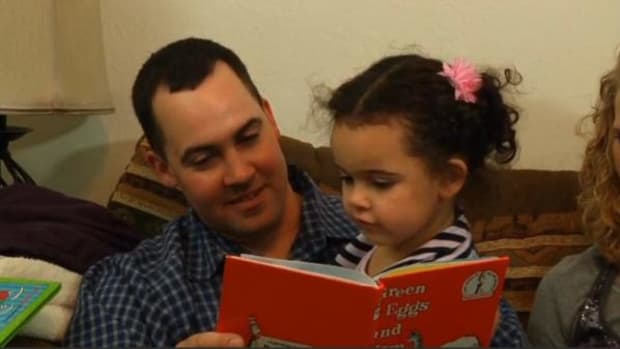 Dusten Brown reads a book to his daughter Veronica, then 3, at their home in Nowata, Oklahoma.