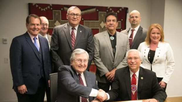 Seated, from left, are: Robert G. McSwain, IHS principal deputy director and Principal Chief Bill John Baker. Standing, from left, are: Charles Grim, deputy director for Cherokee Nation Health Services, Gary Hartz, IHS director of environmental health and engineering, Chuck Hoskin, Cherokee Nation chief of staff, Tribal Council Speaker Joe Byrd, Brian Hail, CEO of W.W. Hastings Hospital and Connie Davis, executive director of Cherokee Nation Health Services.
