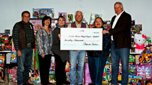 Officials from Cherokee Nation and Cherokee Nation Businesses present a $20,000 check to coordinators for the Cherokee Nation Angel Project. The annual campaign ensures Cherokee children in need receive clothing and other gifts at Christmas.