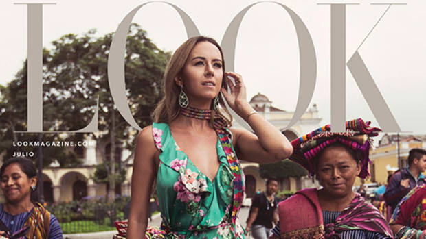 Indigenous, Founder of IX Style, Francesca Kennedy, wears floral dress surrounded by Maya people.