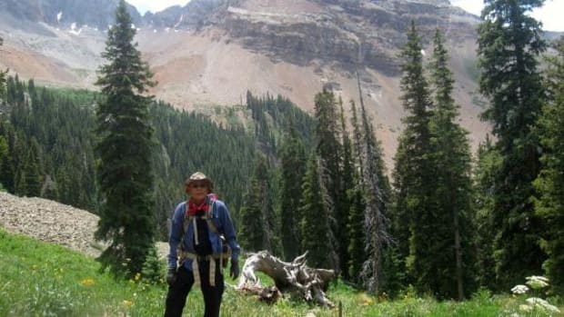 Tommy Allen hiking one of the sacred mountains in Navajo country with Mount Hesperus in the background.