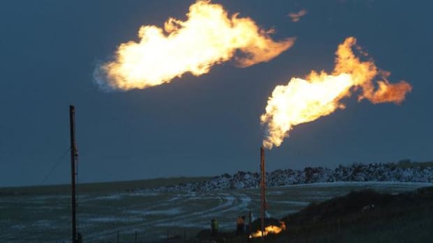 Flares burning waste gas at a well in McKenzie County, N.D., in the Bakken shale oil field.