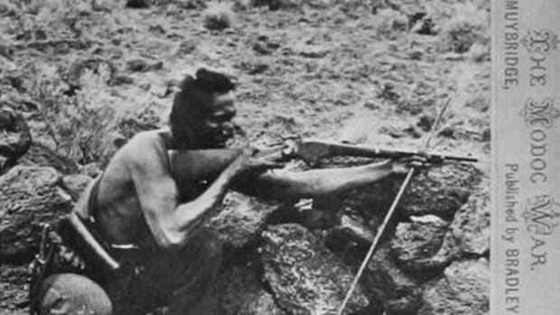 Seeking an image of a Modoc fighter and figuring that one Native looked pretty much like any other, Muybridge posed Warm Springs scout Loa-kum Ar-nuk. The photographer put the scout down sighting a Spencer carbine steadied by a shooting stick. This image from the right emphasizes Loa-kum Ar-nuk’s low stance behind a rock wall and his thousand-yard stare. Transformed into a woodcut, this second image of the scout was published in the June 21, 1873, Harper’s Weekly over the caption “Modoc brave lying in wait for a shot.”