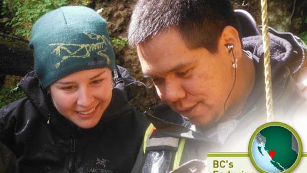 Julia Jackley, graduate student at SFU, and Josh Vickers, of the Heiltsuck First Nation, both on the archaeological team, investigate an artifact. (Photo by Jude Isabella)
