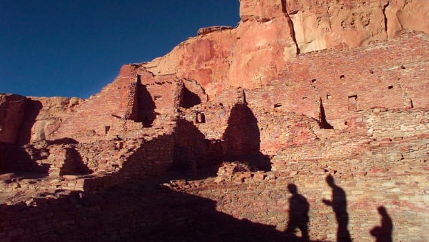 In this Nov. 21, 1996, photo, tourists cast their shadows on the ancient Anasazi ruins of Chaco Culture National Historical Park in New Mexico. (AP Photo/Eric Draper, File)