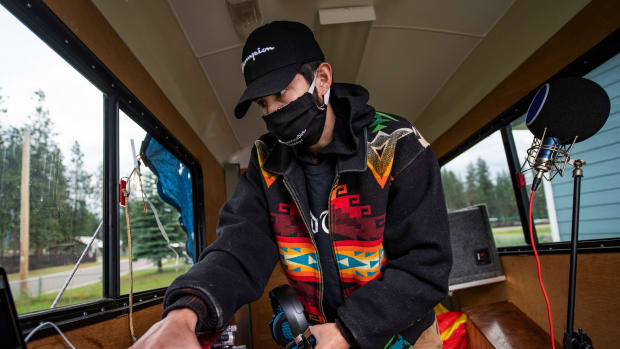 In this photo taken June 16, 2020, Artie Mendoza III, also known as KiidTruth, works on a new track in his home studio in Pablo, Montana. Mendoza created a viral Tik Tok dance and song to promote hand washing, mask wearing and social distancing among the youth on the Flathead Indian Reservation. (AP Photo/Tommy Martino)
