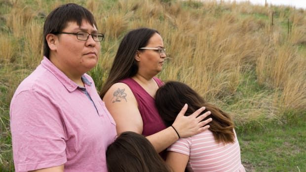 Norma LeRoy, 36, and Alice Johnson, 42,hold their daughters ages 7 and 12 in Valentine City Park in Valentine, Nebraska on May 21. Leroy and Johnson say their daughters’ hair was cut at Cody-Kilgore Unified Schools in 2020. They have filed a lawsuit against the school, saying the hair cutting violated Lakota religious and cultural beliefs and their civil rights. The school’s lawyers have attempted to get the lawsuit dismissed, calling it a lice check and saying they have ended the practice for Lakota children. (Photo by Chris Bowling, Flatwater Free Press)