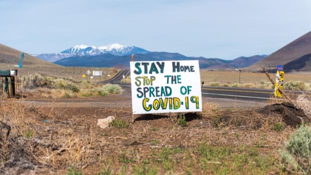 Pictured: COVID-19 prevention sign displayed in front of the San Francisco Peaks.