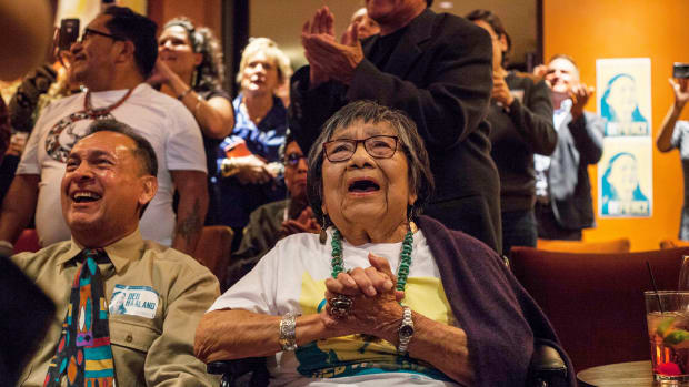 In this Nov. 6, 2018, file photo, Mary Toya, mother to then congresswoman-elect Deb Haaland, celebrates Haaland's win in Albuquerque, N.M. midterms election night. The mother of now U.S. Interior Secretary Deb Haaland has died, authorities said Sunday, Oct. 17, 2021. Officials with the Department of the Interior didn't immediately release Mary Toya's age or a cause of death. In a statement, Haaland's spokeswoman Melissa Schwartz said "we celebrate Mary Toya's long life and are grateful for her 25 years of service to Native students as a member of the Interior team within Indian Affairs. (AP Photo/Juan Labreche, File)