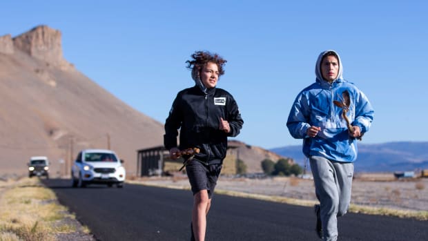 Christian Jackson, left, and Blaiwas Eaglepipe run a leg of the annual Modoc Ancestral Run on Oct. 9 with The Peninsula in the background. (Photo by Arden Barnes, (Klamath Falls) Herald and News)