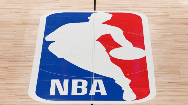 FILE - The NBA logo in shown on a basketball court in Lake Buena Vista, Fla., in this Friday, Aug. 28, 2020, file photo. Pacers coach Rick Carlisle says his new team has a “very high” vaccination rate but declined to give a specific number because of privacy concerns. He did say Monday during NBA media day that all members of the Indiana coaching staff are fully vaccinated. Carlisle is back in Indiana, where he coached from 2003 through 2007. Training camps open Tuesday and the pandemic will affect a third NBA season and already means some players will be missing on media day.(AP Photo/Ashley Landis, Pool, File)
