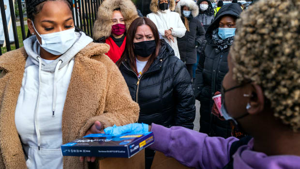 People line up and receive test kits to detect COVID-19 as they are distributed in New York on Dec. 23, 2021. The COVID-19 surge caused by the omicron variant means once-reliable indicators of the pandemic's progress are much less so, complicating how the media is able to tell the story. (AP Photo/Craig Ruttle, File)