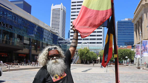Herbert Bropho with a fifty-year-old flag from Aboriginal Tent Embassy in Australia. (Photo by Kearyn Cox, NITV)