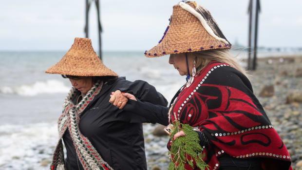 Lummi Tribal citizens Ellie Kinley, left, and Raynell Morris, president and vice president of the non-profit Sacred Lands Conservancy known as Sacred Sea, lead a prayer for the repatriation of southern resident orca Sk’aliCh’elh-tenaut — who has lived and performed at the Miami Seaquarium for over 50 years — to her home waters of the Salish Sea at a gathering Sunday, March 20, 2022, at the sacred site of Cherry Point in Whatcom County, Wash. (Photo by The Bellingham Herald)