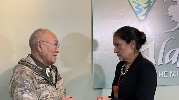 Vietnam Veteran Nelson Angapak Sr., Yup’ik and a former vice president of the Alaska Federation of Natives, speaks with Interior Secretary Deb Haaland, Laguna Pueblo, on April 21, 2022, at the Bureau of Land Management office in Anchorage, Alaska, shortly after she announced that 28 million acres of land would be open for selection by Vietnam-era veterans for Native allotments. (Photo by Joaqlin Estus/Indian Country Today)