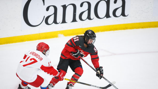 Russia's Fanuza Kadirova, left, vies for the puck with Canada's Victoria Bach during the International Ice Hockey Federation's women's championships game in Calgary, Alberta, on Aug. 22, 2021. Bach is Mohawk of the Bay of Quinte in Canada. (Photo by Jeff McIntosh/The Canadian Press via AP)