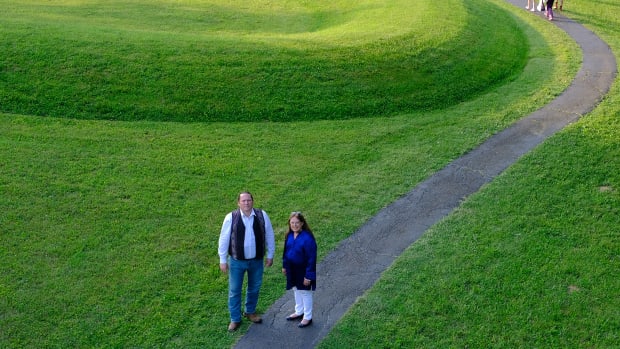 Ben Barnes, chief of the Shawnee Tribe and Glenna Wallace chief of the Eastern Shawnee Tribe of Oklahoma pause at the entrance to the Great Serpent Mound in Peebles, Ohio (Photo by Mary Annette Pember)