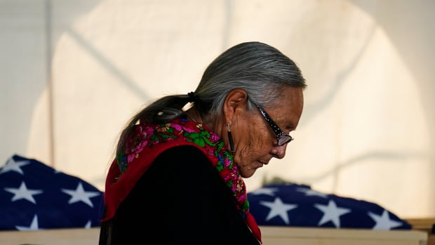 Ione Quigley, the Rosebud Sioux's historic preservation officer, returns to her seat after speaking during a ceremony at the U.S. Army's Carlisle Barracks, in Carlisle, Pa., Wednesday, July 14, 2021. The disinterred remains of nine Native American children who died more than a century ago while attending a government-run school in Pennsylvania were headed home to Rosebud Sioux tribal lands in South Dakota on Wednesday after a ceremony returning them to relatives. (AP Photo/Matt Rourke)