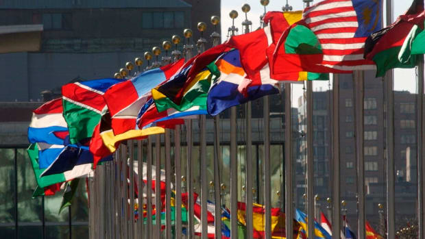 Flags of member nations fly high in this 2005 photo at the United Nations, which is hosting a worldwide climate change conference Nov. 1-12, 2021, in Glasgow, Scotland. Indigenous leaders, however, are facing barriers gaining access to the conference. ( UN Photo by Joao Araujo Pinto via Creative Commons)