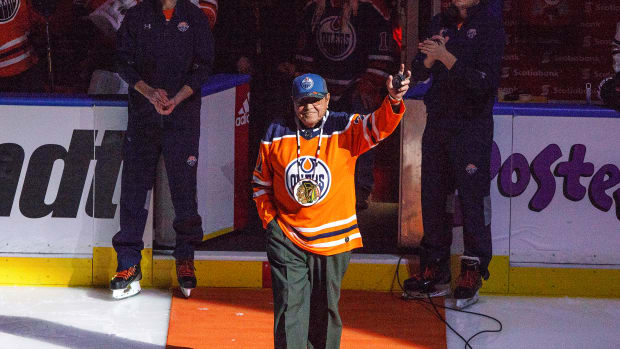 Former Chicago Blackhawks player Fred Sasakamoose is honored at the Edmonton Oilers-Chicago Blackhawks NHL hockey game Dec. 29, 2017, in Edmonton, Alberta. Sasakamoose is recognized as becoming the league's first Canadian aboriginal player in 1953, and he turned into a First Nations hero. But historians and the Hall of Fame would give that distinction to Mohawk player Paul Jacobs if he played in a game during the 1918-19 season. (Jason Franson/The Canadian Press via AP, File)