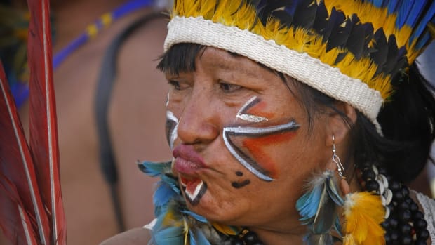 An Indigenous person from the Amazonian Patamona tribe in the state of Roraima, Brazil, attends a demonstration in 2008 over Indigenous rights to autonomy over their lands. (AP FILE Photo/Eraldo Peres)