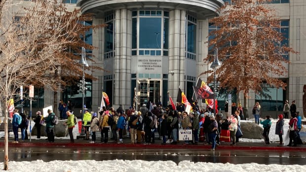 Dozens of tribe members and other protesters beating drums and waving signs rally in front of the federal courthouse in Reno, Nev. Thursday, Jan. 5, 2023, as a court hearing began over a lawsuit seeking to block a huge lithium mine planned near the Nevada-Oregon line about 200 miles north of Reno. (AP Photo/Scott Sonner)