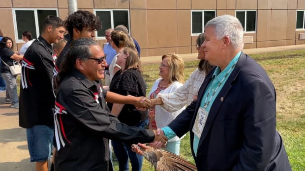 Mark Vargo, right, shakes hands with members of the Wambli Ska Society on Sept. 13, 2022, in Pierre. (Courtesy of SD Attorney General’s Office)