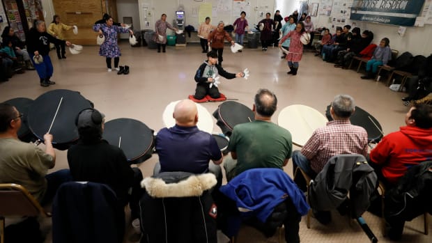 People take part in an Alaska Native dance Jan. 20, 2020, in Toksook Bay, Alaska, a mostly Yup'ik village on the edge of the Bering Sea. The Federal Emergency Management Agency provided financial aid applications in both Yup'ik and Inupiaq for Alaska Native speakers following a typhoon, but the translated materials were so bungled they did not make sense. (AP Photo/Gregory Bull, File)