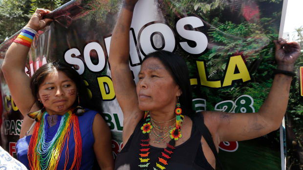 Indigenous women from the Amazon protest the environmental policies of President Lenin Moreno's government, in Quito, Ecuador, Monday, March 12, 2018. Protesters are demanding to meet with Moreno to express their rejection of oil and mining in the rainforest. (AP Photo/Dolores Ochoa)