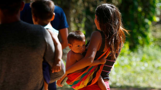 A Yanomami woman carries a toddler on the property of the Saude Indigenous House, a center responsible for supporting and assisting Indigenous people in Boa Vista, Roraima state, Brazil, Wednesday, Jan. 25, 2023. The government declared a public health emergency for the Yanomami people in the Amazon, who are suffering from malnutrition and diseases such as malaria. (AP Photo/Edmar Barros)