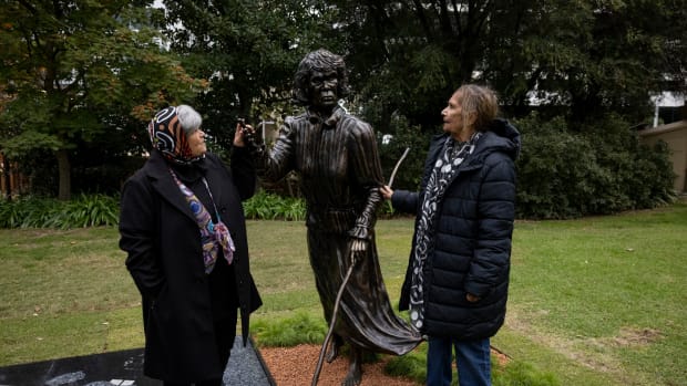 Aunty Milli Penny and Aunty Liz Hayden stand beside their ancestor, a statue of Balbuk (Fanny Balbuk Yooreel. (Photo courtesy of Government House Western Australia)