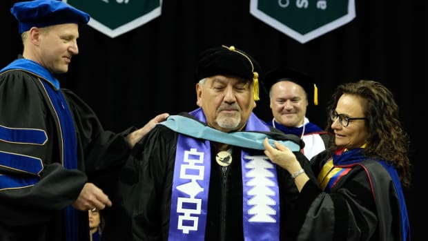 The doctoral hood is conferred in May 2022 for Artley Skenandore, an Oneida educator in Wisconsin, who is one of four graduates at the University of Wisconsin-Green Bay to receive the nation's first-ever doctorate in First Nations Education.  From left are Dr. Pieter deHart, associate vice chancellor for graduate studies and research; Skenandore; and Dr. J.P. Leary and Dr. Lisa Poupart, both with the First Nations Studies department. (Photo courtesy of Daniel Moore/University of Wisconsin-Green Bay)