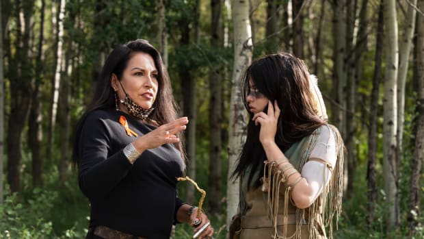 Creative producer Jhane Myers, Comanche/Blackfeet, left, and actress Amber Midthunder as Naru, discuss a scene during the filming of Disney's  20th Century Studio’s film, "Prey," released in 2022. (Photo by David Bukach, courtesy of Disney Studios)