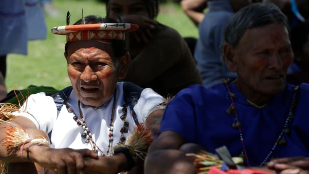 Indigenous people from Ecuador's Amazon region rest during a demonstration outside the Constitutional Court in Quito, Ecuador, making a 23-year legal battled over oil drilling in the rainforest.(AP Photo/Dolores Ochoa)