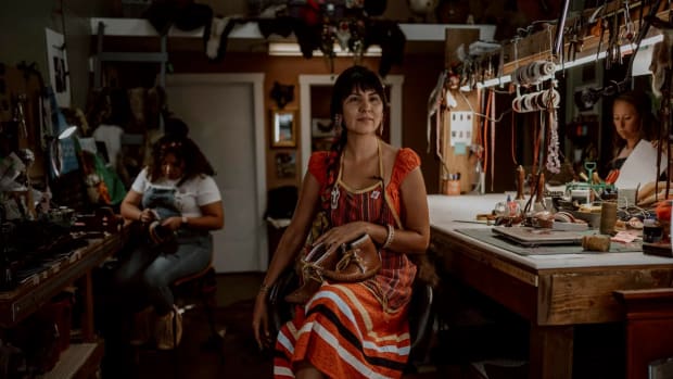 Shauna White Bear poses in her shop. She founded the company White Bear Moccasins. (Photo courtesy Chloe Nostrant)