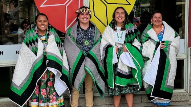 First-ever Ph.D. graduates in Indigenous Health at the University of North Dakota are, from left, Danya Carroll, Cole Allick, Amy Stiffarm and Mona Zuffante. All wear star quilts that the department – under the auspices of the School of Medicine and Health Sciences – gifted them. (Photo courtesy of the University of North Dakota)