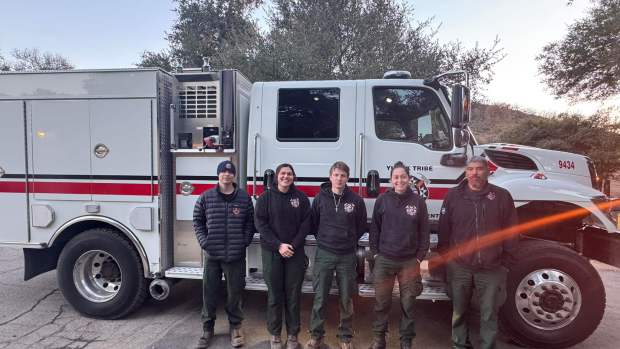 Members of the Yurok Nation fire department stand in front of a Yurok firefighting vehicle as they prepared to deploy to the Los Angeles area to fight wildfires. (Photo courtesy of Yurok Nation)