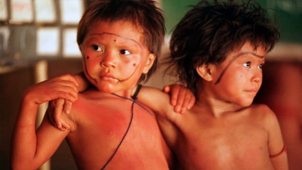 FILE - In this March 22, 1998, file photo, Yanomami children stand arm in arm in the village of Demini in the Amazon jungle in Brazil. On Monday, May 24, 2021, a Supreme Court justice ordered the government to protect Indigenous populations, including the Yanomami, threatened in recent weeks by illegal miners who appear to have been emboldened by support for their industry from President Jair Bolsonaro. (AP Photo/Dario Lopez-Mills, File)