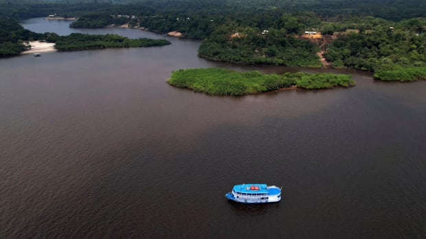 Electoral workers on a boat loaded with electronic voting machines to be taken to voting centers ahead of tomorrow's elections, navigate the Rio Negro, in Manaus, Amazonas state, Brazil, Saturday, Oct. 1, 2022. (AP Photo/Edmar Barros) amazon