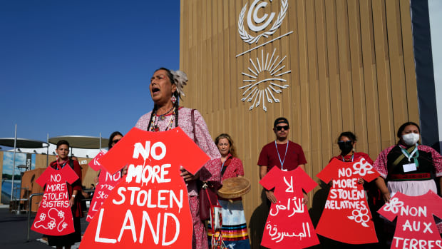 Demonstrators hold signs as part of a protest demanding no more stolen relatives and stolen land with the group Indigenous Women Action at the COP27 United Nations climate conference on Tuesday, Nov. 15, 2022, in Sharm el-Sheikh, Egypt. (AP Photo/Peter Dejong)