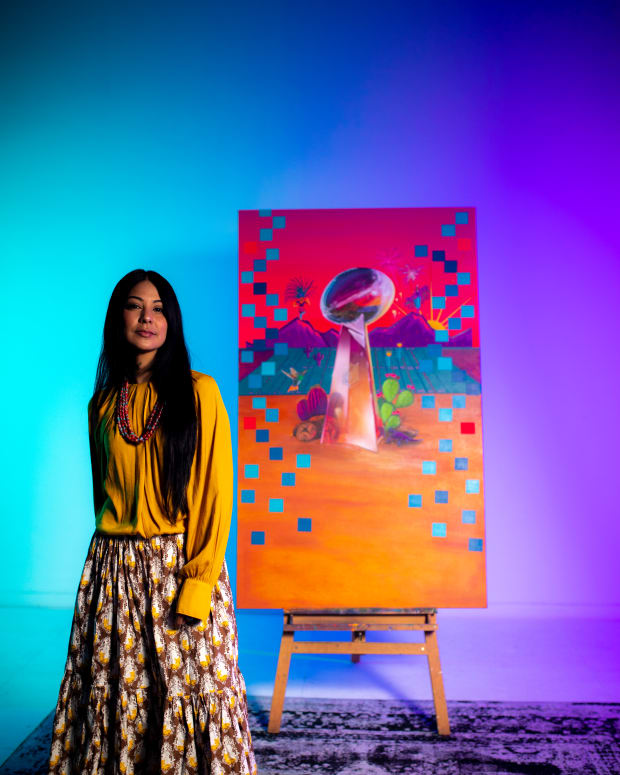 Phoenix-based artist Lucinda Hinojos, who has been tapped as the NFL's marquee artist for Super Bowl LVII, is shown in her studio with her featured design.  Her selection marks the first time an Indigenous artist’s works will be featured at the Super Bowl, which will be played on Feb. 12, 2023, in Glendale, Arizona. Hinojos is Mexican-American as well as Pascua Yaqui, Chiricahua Apache, White Mountain Apache, and Pima. (Photo courtesy of the National Football League)