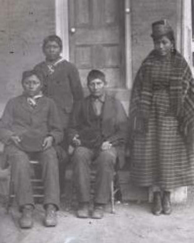 Albert Mekko, 17, (seated, center) from the Seminole Nation of Oklahoma, died and was buried at the Carlisle Indian Industrial School in 1881, two years after arriving at the school. More than 140 years later, Mekko's remains are set to be returned to his family and tribe in Fall 2024. In this photo, believed to have been taken in 1879, Mekko is shown  with three other students who arrived with him on Oct. 27, 1879. (Historical photo via the Cumberland  County Historical Society)